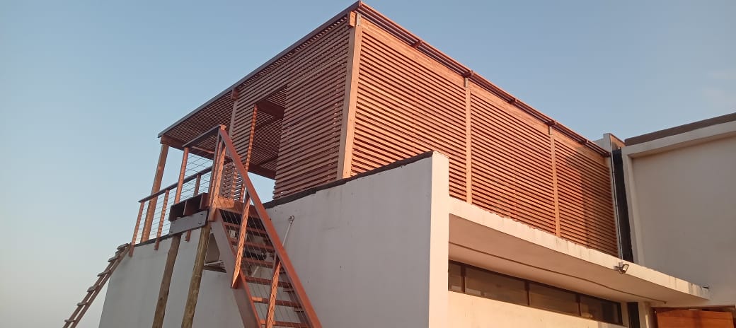 Slatted timber pergola with outdoor seating area