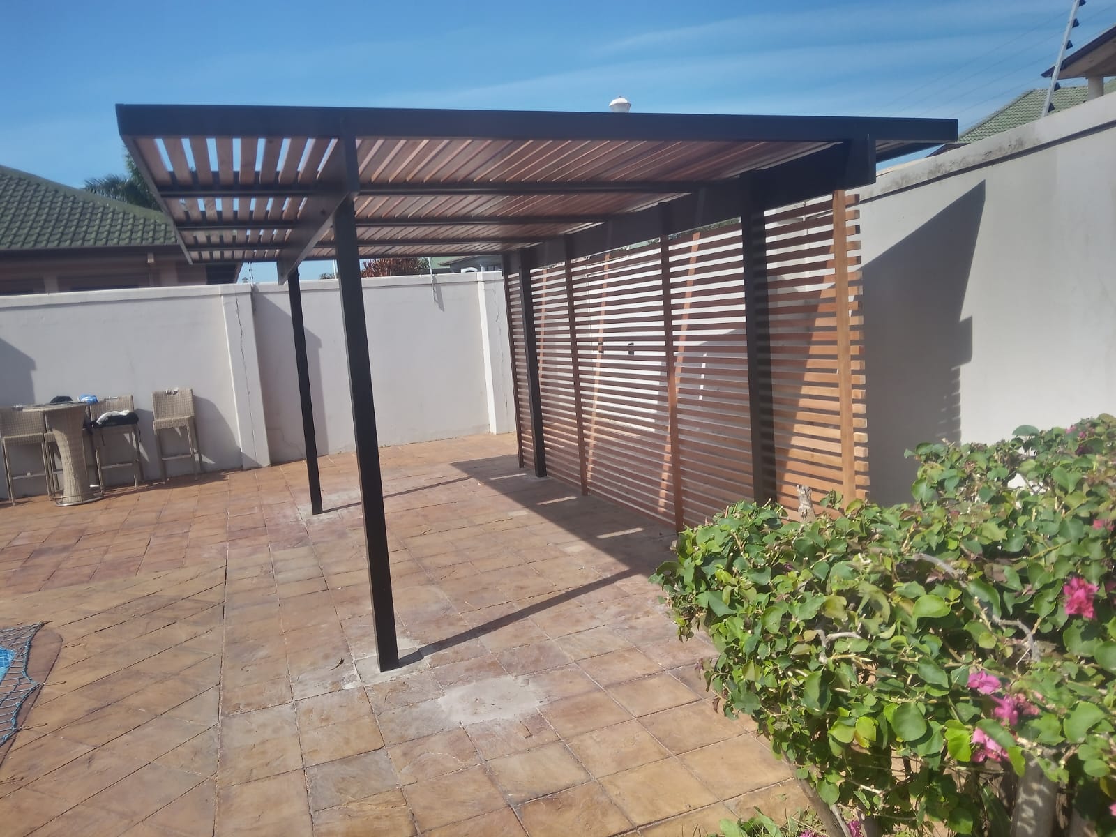 Modern slatted pergola outdoor living space